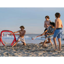 Load image into Gallery viewer, Picture of kids playing at the beach with the True Laxyard Backyard Lacrosse Kit (3 Short Sticks, 1 Ball, 1 Mini Goal)
